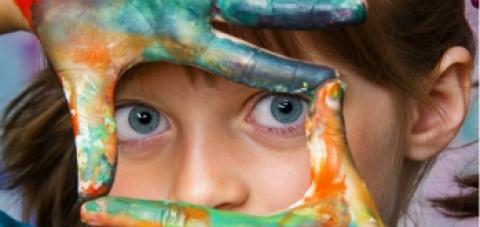 A child with paint on her fingers.