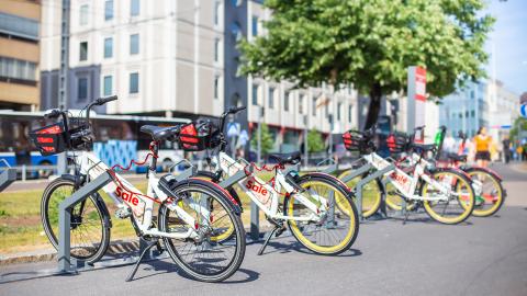 City bikes on stands along the street.