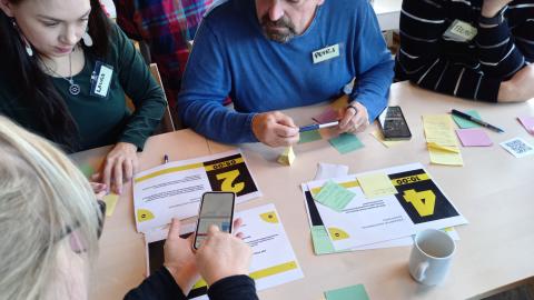 Four people working at a table during a workshop.