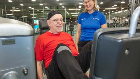 Kauko Rahko works out at the leg press at the Tampere Swimming Centre gym under the guidance of Sari Helminen.