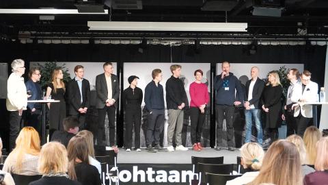 Henkilöitä seisomassa lavalla.