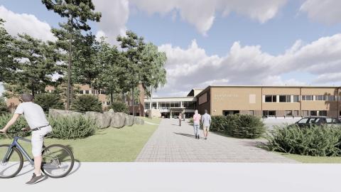 Havainnekuvassa matala koulurakennus.