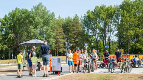 Young people and their bicycles in a traffic park.