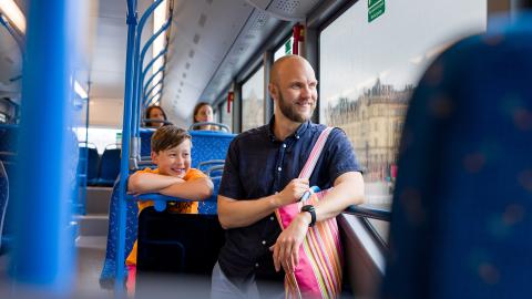 A man and a boy on a bus.