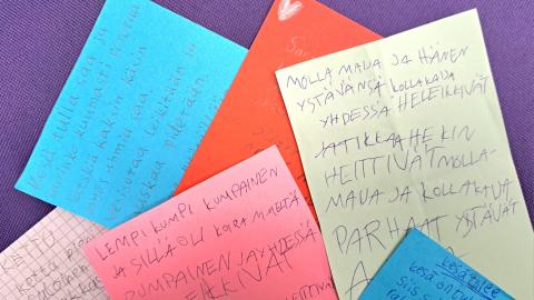 Different colored papers with poetry texts on them.