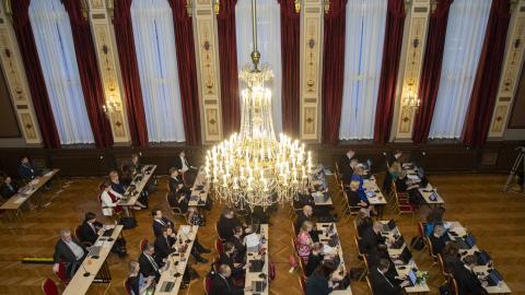 Valtuutetut istuvat Raatihuoneen juhlasalissa valtuuston kokouksessa.