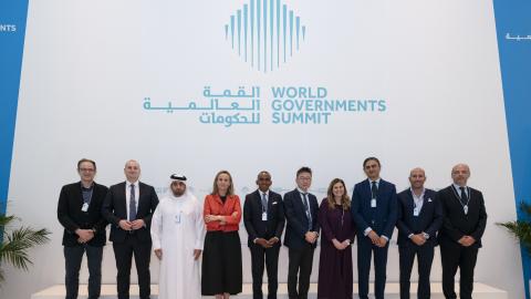 Ihmiset seisovat virallisesti poseeraten kokouksessa. 