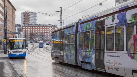 Bussi ja ratikka ajavat kadulla.