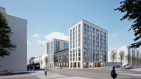 Kuvassa uusia valkoisia kerrostaloja kadun risteyksen takana.