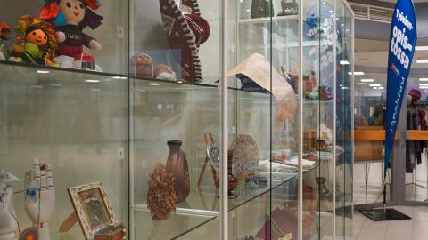 A display case with handicrafts behind glass.