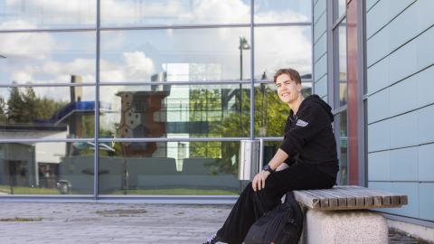 Veeti Granberg is sitting on a bench in the courtyard of the Sampo Central High School.