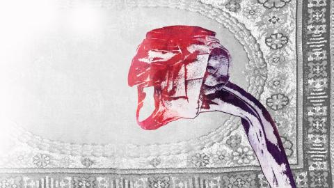 The graphic work features a grey carpet in the background and a tall figure in front wearing a red mask.