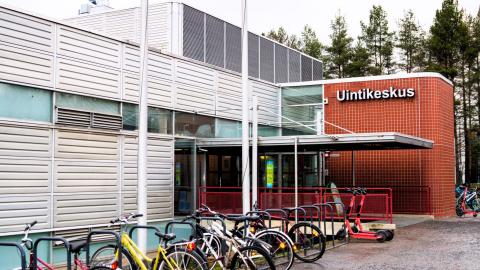 Bicycles on a rack in front of the Tampere Swimming Centre.