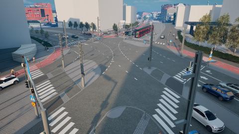 Kuvassa liikennevalo-ohjattu risteys, raitiovaunu, autoja ja muita kulkijoita.