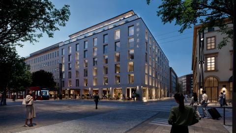 Kuvassa uusi rakennus iltavalaistuksessa. 