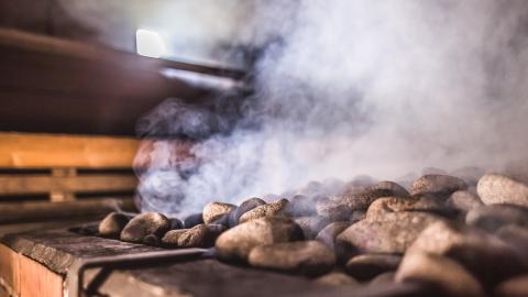 The stones in the sauna stove are steaming.