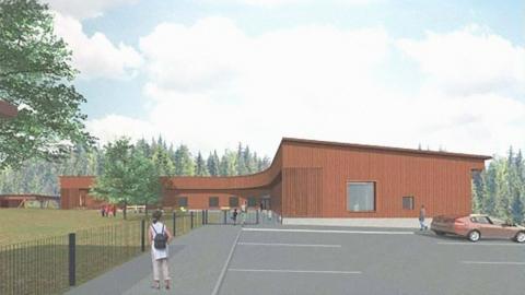 Suunnittelukuva vaaleanruskeasta puupintaisesta päiväkotirakennuksesta. kesämaisemassa.