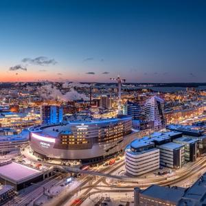 An atmospheric aerial view of Tampere city centre in the evening light. Nokia Arena in the foreground.