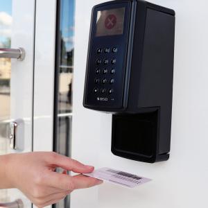 The customer inserts their library card into the self-service library reader. 