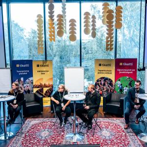 Panelistit keskustelemassa tapahtuman lavalla.