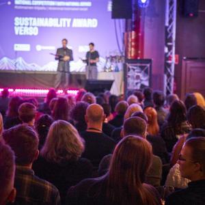 Lavalla kaksi esiintyjää ja yleisöä.