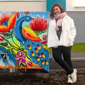 The artist leans against the electrical cabinet they painted in South Hervanta.