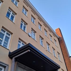 A wall with lots of windows and an entrance canopy.