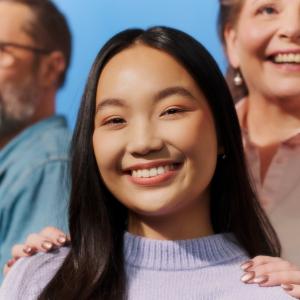 The photo shows three people of different ages.