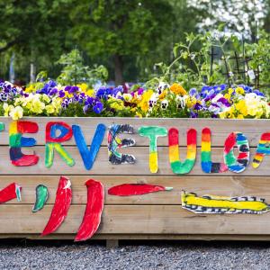 A gardening container with a colorful welcome message on the side.