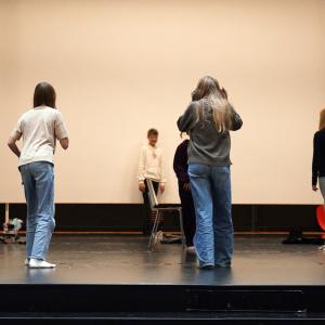 Five children stand on the stage.