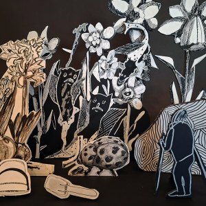 A drawing installation with figures and flowers.