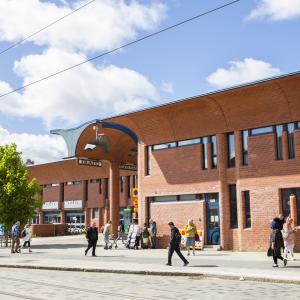 The red-brick shopping center building in the city centre of Hervanta in the summer.