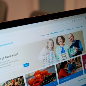 A computer screen displaying a website. Three people are smiling in the banner image.