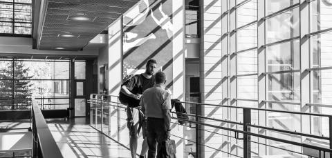 Opiskelijat keskustelevat käytävällä.