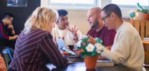 Monikulttuurinen ryhmä keskustelemassa.