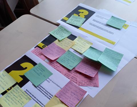 Post it notes on a table during a worshop.