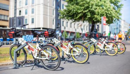 Kaupunkipyöriä telineissä kadun varrella.