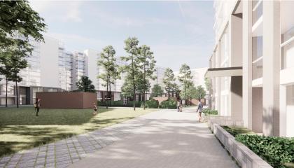 Kivetty kulkuväylä, nurmikkoa ja vaaleita rakennuksia molemmin puolin.