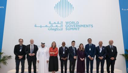 Ihmiset seisovat virallisesti poseeraten kokouksessa. 