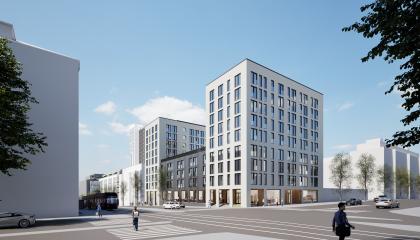 Kuvassa uusia valkoisia kerrostaloja kadun risteyksen takana.