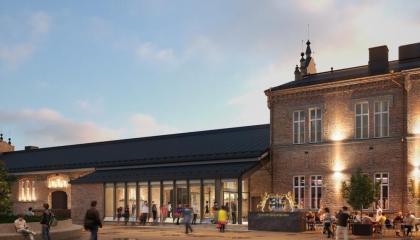 Havainnekuva remontoidusta tiilirakennuksesta, jossa lasikuisti.