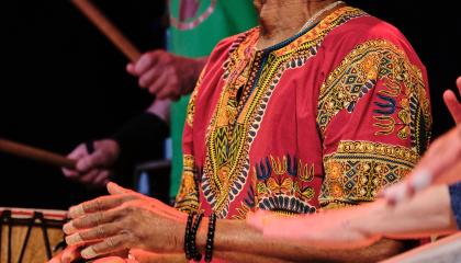 Henkilö soittaa käsirumpua.