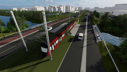 Kuvassa silta, ratikka, vihreää ja taloja taustalla.