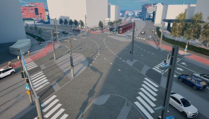 Kuvassa liikennevalo-ohjattu risteys, raitiovaunu, autoja ja muita kulkijoita.