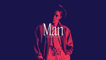 A man in the middle of the picture in red, the background is dark.