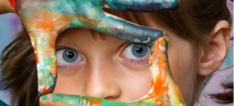 A child with paint on her fingers.
