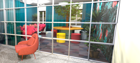 Aula- ja neuvottelutilassa on paljon erivärisiä huonekaluja: pieniä pöytiä, tuoleja ja sohva. Keskellä tilaa on lasiseinä.