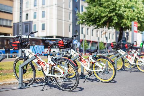 City bikes on stands along the street.
