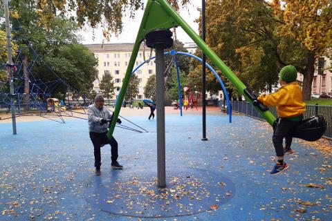 Aikuinen ja lapsi kiikkuvat mobiluslaitteessa.