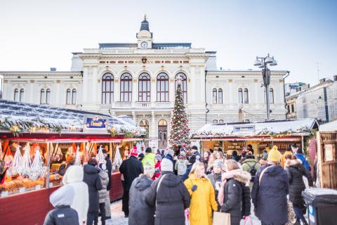 People at Christmas Market, Town Hall in the background.